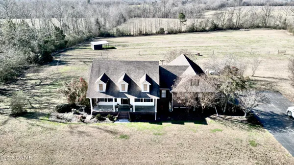 a view of a room with wooden floor and chandelier