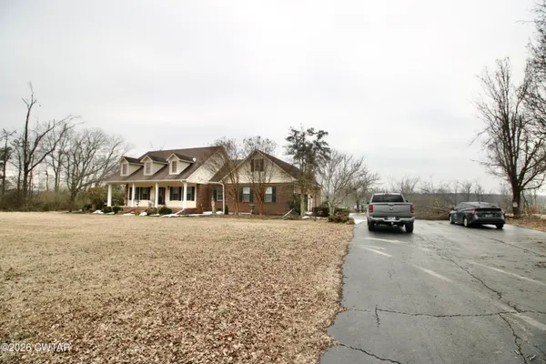 a view of a room with wooden floor window and a ceiling fan