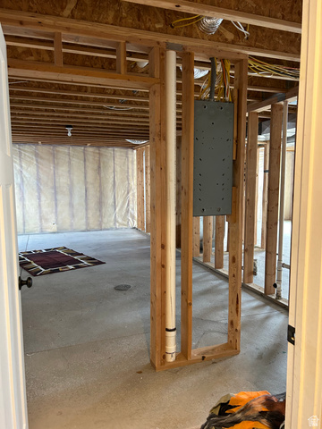 175 North 100th West Centerfield, UT 84622 - Photo 28 of 32 Unfinished basement with concrete flooring, exposed wood framing, ceiling joists, and visible wiring infrastructure. Basement is also plumbed.