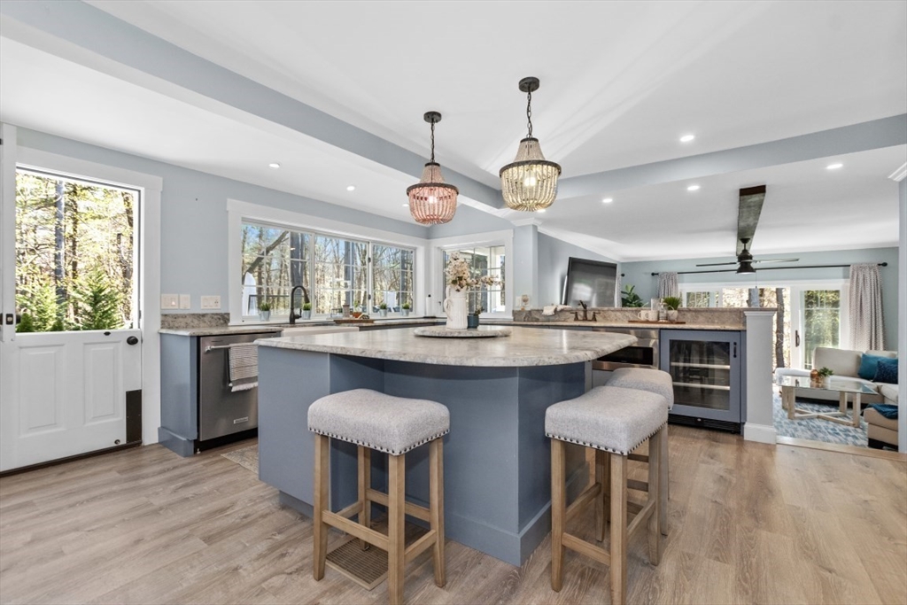 154 Topsfield Road Boxford, MA 01921 - Photo 2 of 39 a kitchen with stainless steel appliances granite countertop a table chairs sink and cabinets