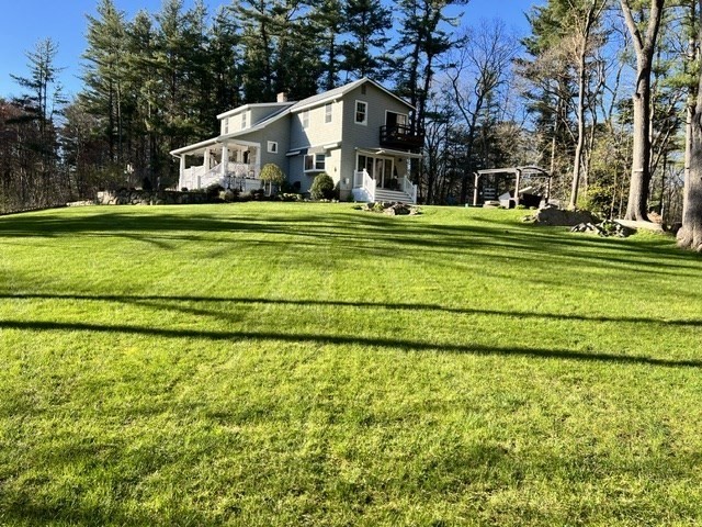 154 Topsfield Road Boxford, MA 01921 - Photo 24 of 39 a view of a white house with a big yard and large trees