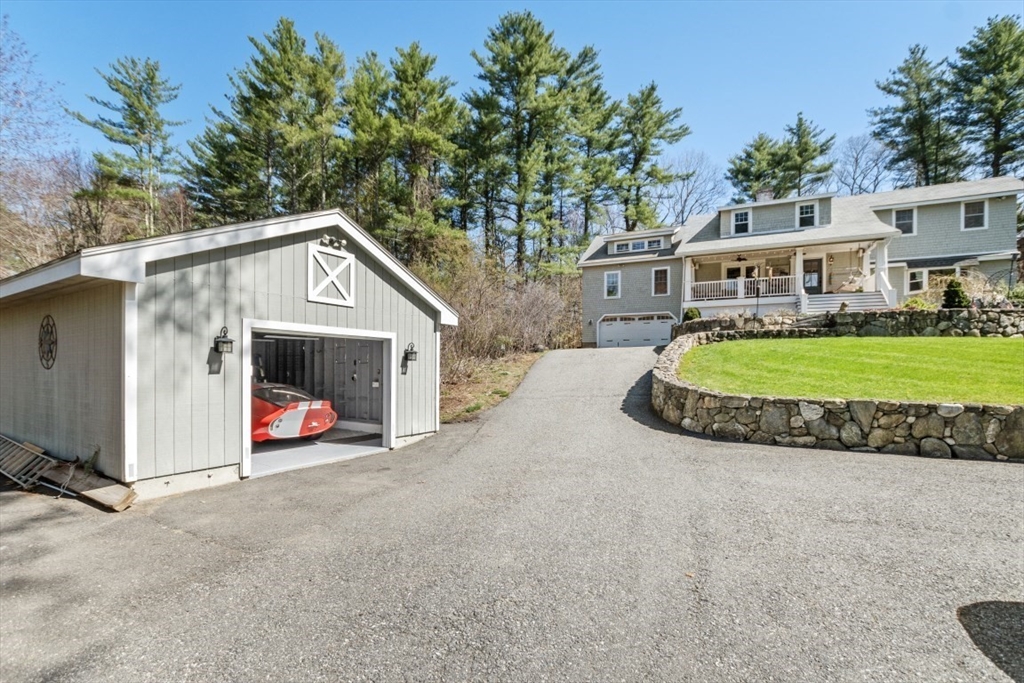 154 Topsfield Road Boxford, MA 01921 - Photo 31 of 39 a front view of a house with a yard and garage