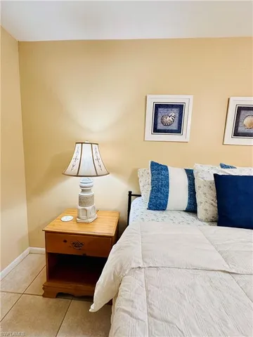 a bed room with a bed and a lamp
