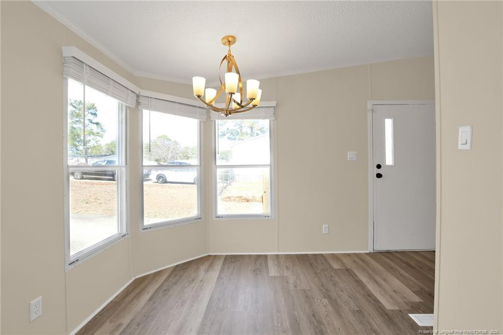 51 Old Forte Trail Spring Lake, NC 28390 - Photo 16 of 33 a view of an empty room with wooden floor and a window