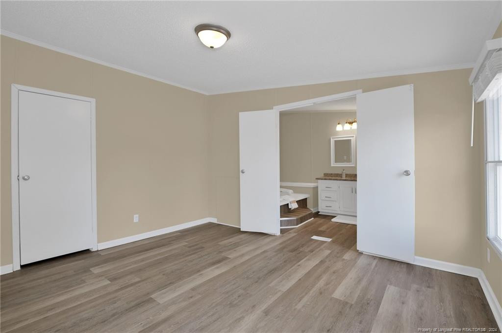 51 Old Forte Trail Spring Lake, NC 28390 - Photo 20 of 33 an empty room with wooden floor and a window