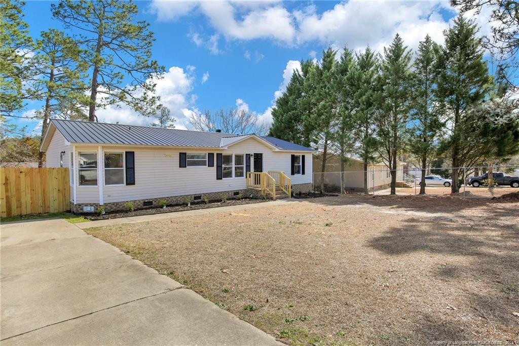 51 Old Forte Trail Spring Lake, NC 28390 - Photo 2 of 33 a front view of a house with a yard and garage