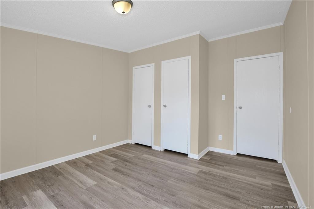 51 Old Forte Trail Spring Lake, NC 28390 - Photo 27 of 33 a view of an empty room with wooden floor and windows