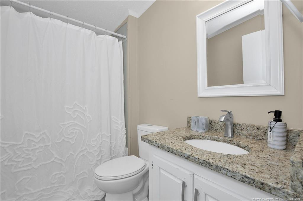 51 Old Forte Trail Spring Lake, NC 28390 - Photo 28 of 33 a bathroom with a granite countertop sink and a mirror
