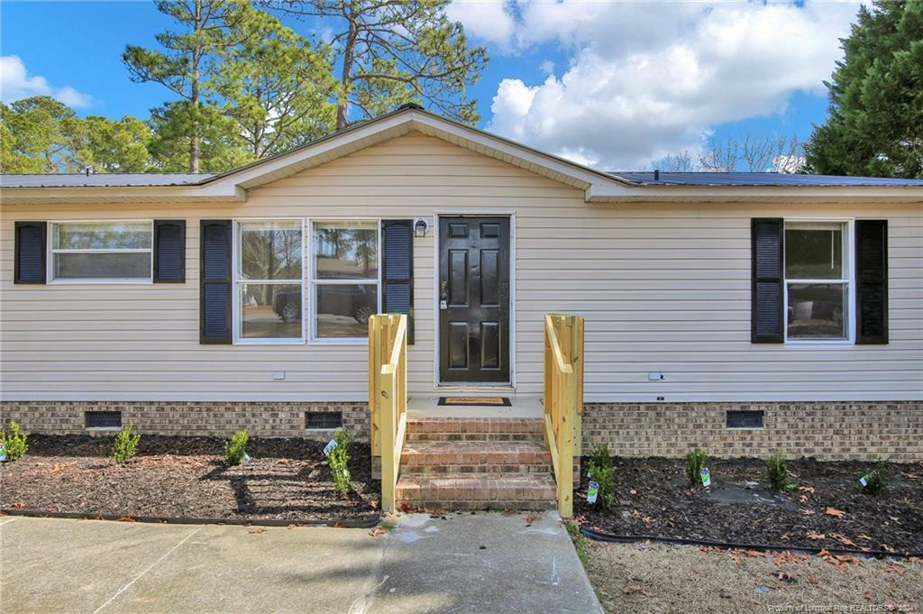 51 Old Forte Trail Spring Lake, NC 28390 - Photo 4 of 33 a front view of a house with garden