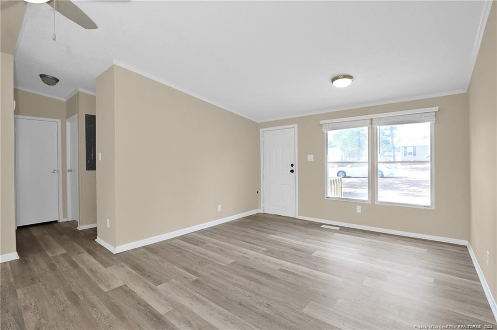 51 Old Forte Trail Spring Lake, NC 28390 - Photo 10 of 33 an empty room with wooden floor and windows