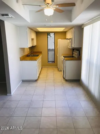 a kitchen with stainless steel appliances granite countertop a refrigerator a stove and a sink