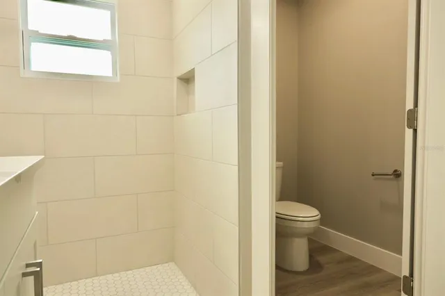 a bathroom with a toilet and a shower