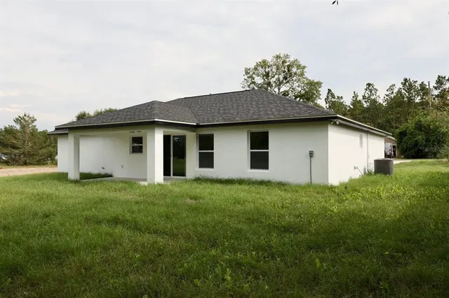 a house with green field in front of it