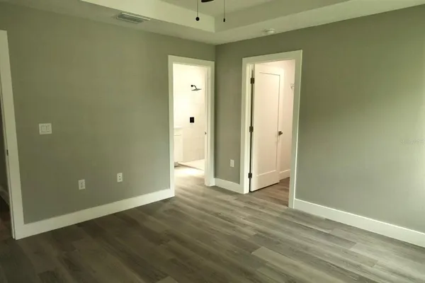 an empty room with wooden floor and closet