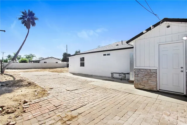 a bedroom with a bed and a potted plant