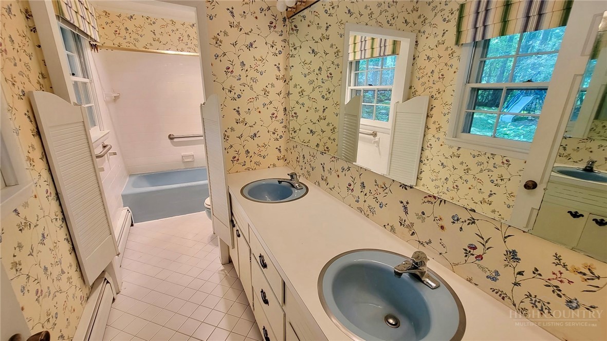 247 Crest Drive Boone, NC 28607 - Photo 11 of 19 a bathroom with a sink and a washing machine