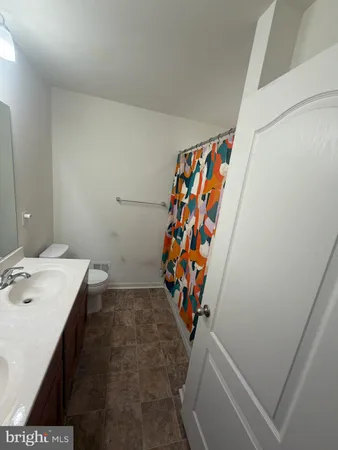 a bathroom with a sink mirror and toilet