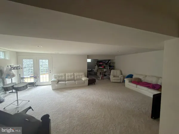 a front view of a house with lots of trees and plants