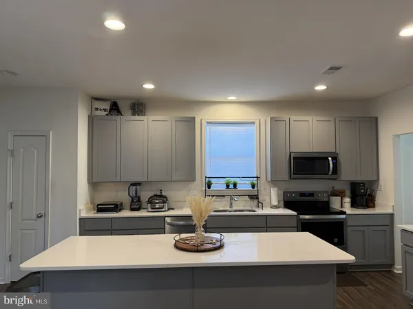 a kitchen with a sink a stove and cabinets