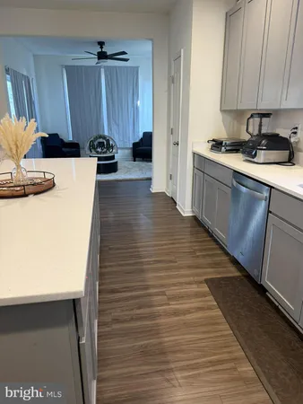 a kitchen with sink a refrigerator and cabinets