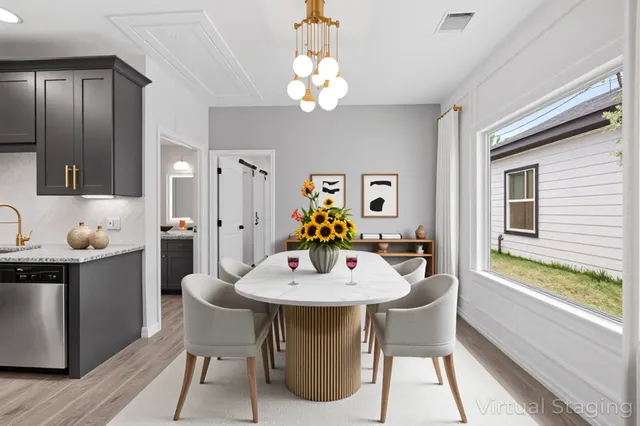 a view of a dining room with furniture a chandelier and wooden floor