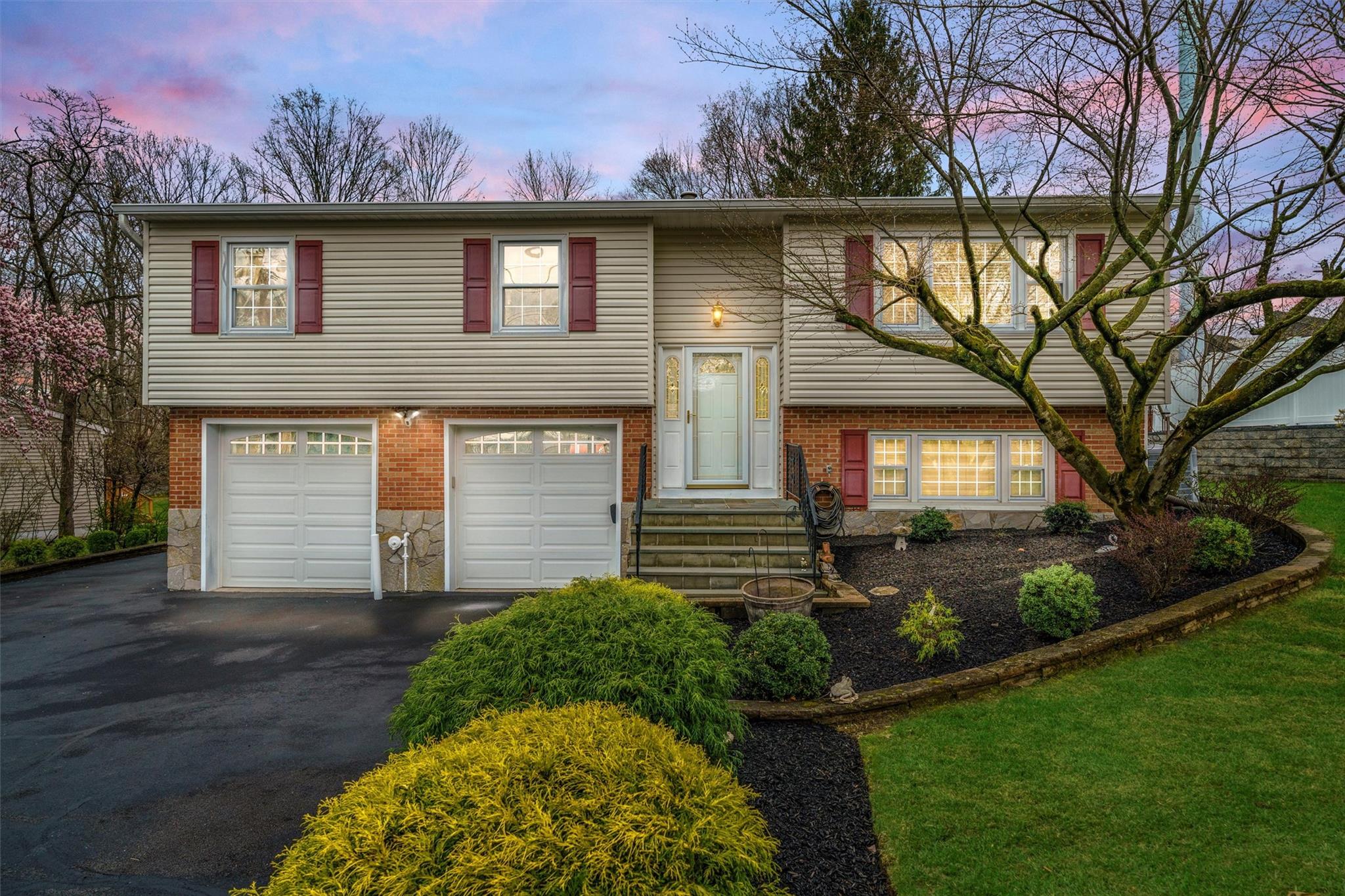 a front view of a house with garden