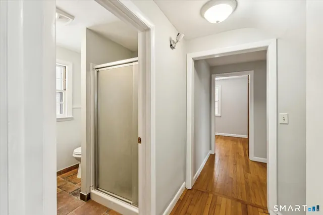 a view of a hallway with wooden floor