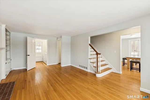 a view of a room with wooden floor and stairs
