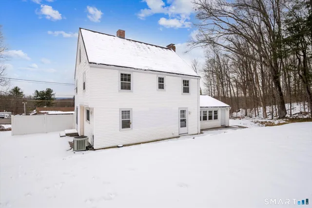 a view of a house with a snow in the yard
