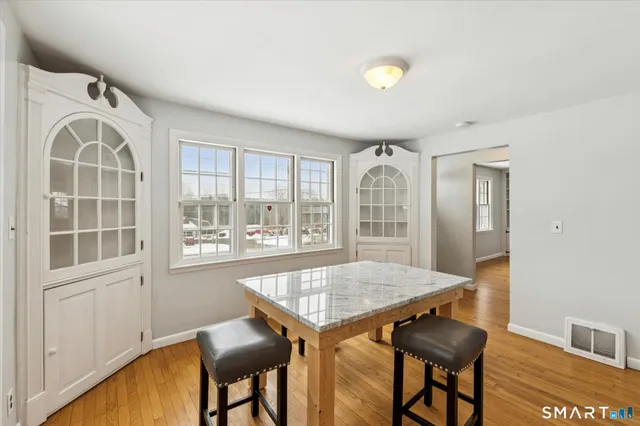 a view of a dining room with furniture window and wooden floor
