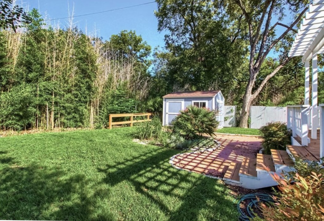 702 West N Loop Boulevard Austin, TX 78751 - Photo 20 of 23 A quaint backyard retreat featuring a versatile storage shed and a charming patio.