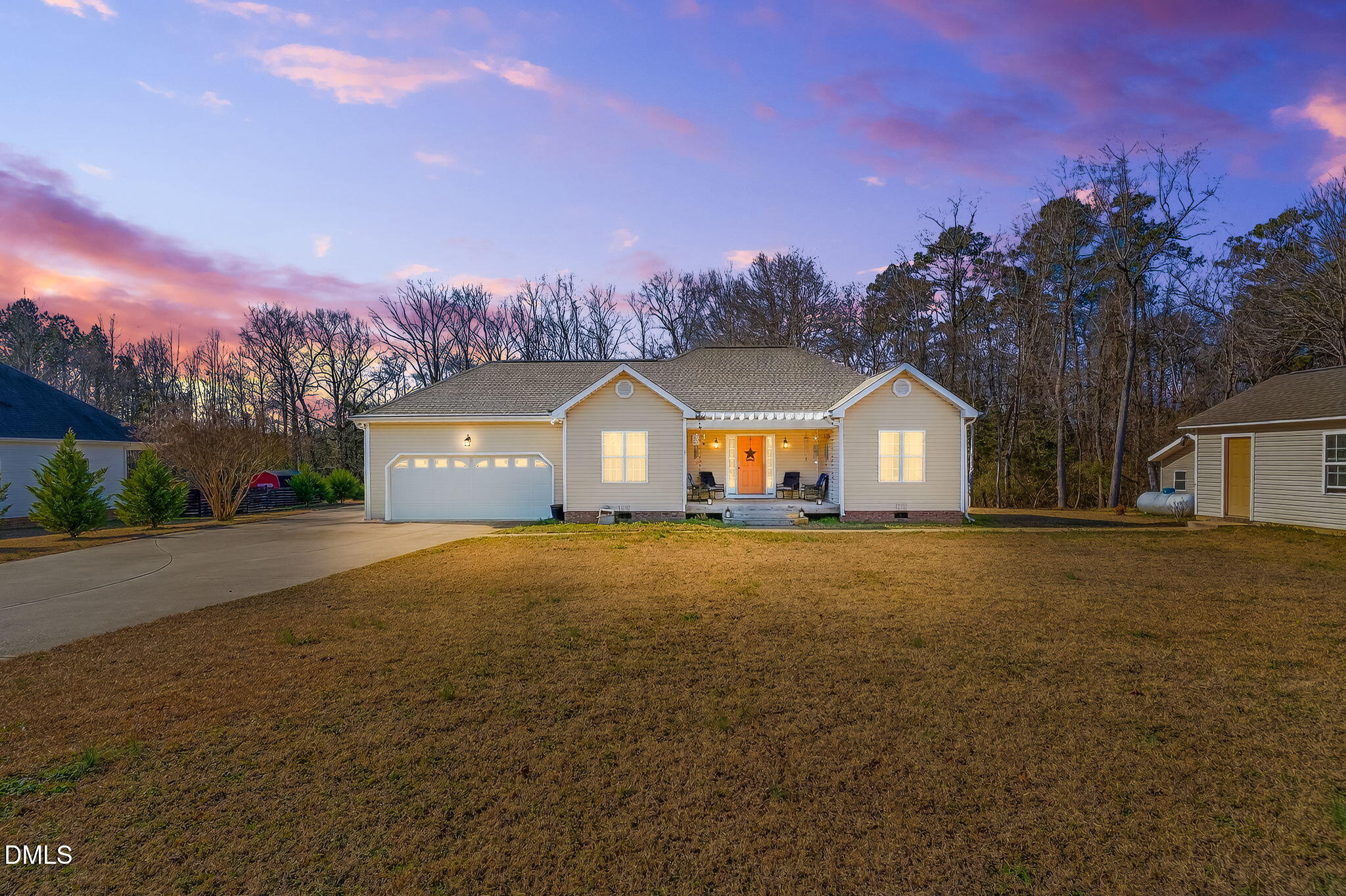 a front view of a house with a yard and a garage
