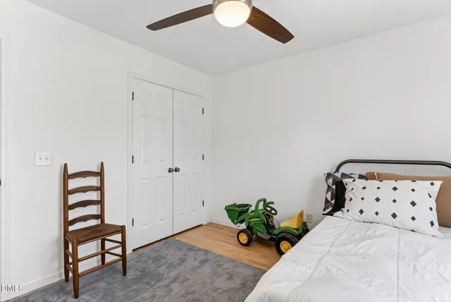 a view of a house with a yard and tree
