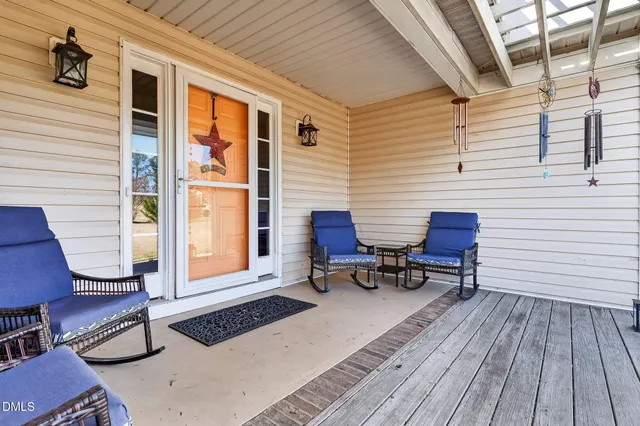 a living room with furniture and kitchen view