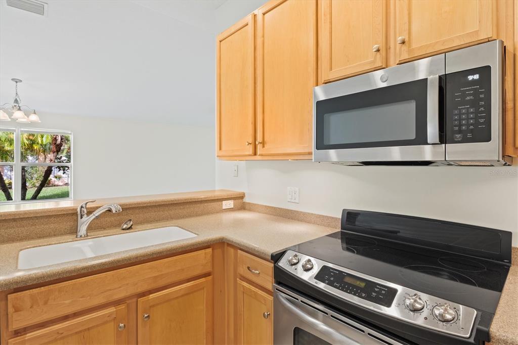 13222 Huerta Street Venice, FL 34293 - Photo 15 of 85 a kitchen with a stove and a microwave