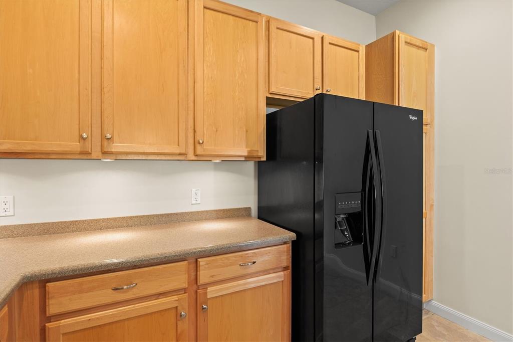 13222 Huerta Street Venice, FL 34293 - Photo 16 of 85 a kitchen with a refrigerator and cabinets