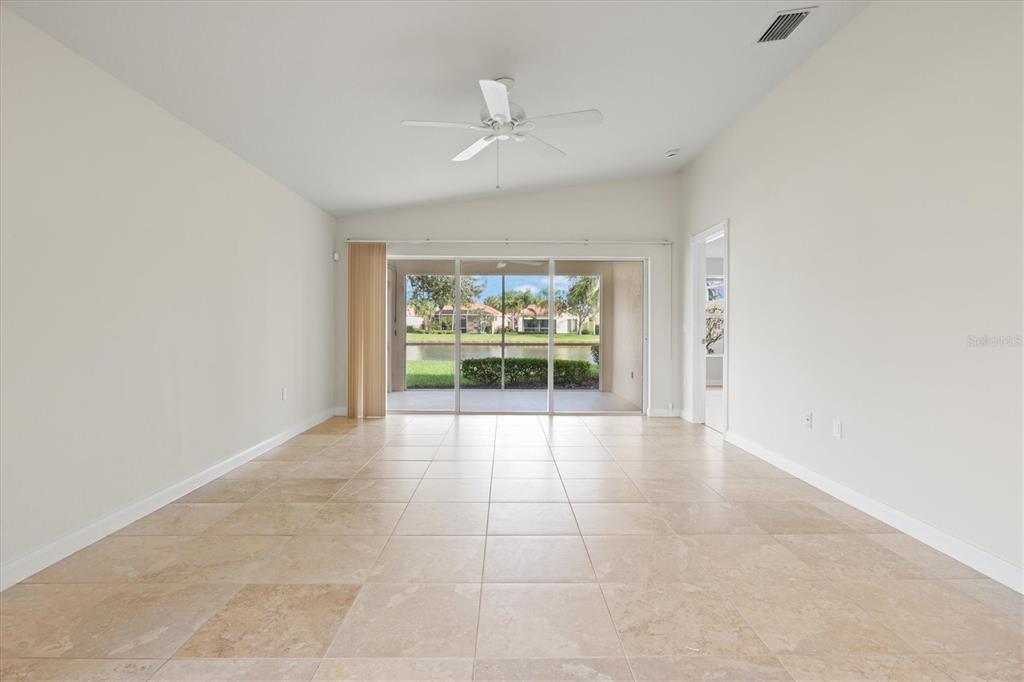 13222 Huerta Street Venice, FL 34293 - Photo 20 of 85 an empty room with windows and yard
