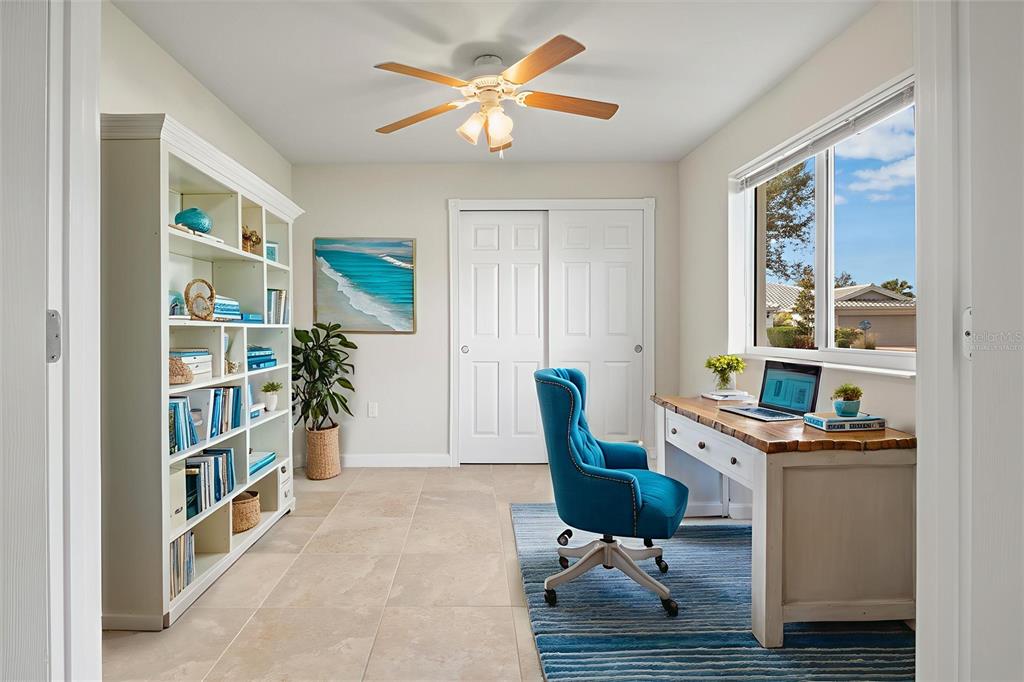 13222 Huerta Street Venice, FL 34293 - Photo 24 of 85 a room with furniture a rug and a book shelf
