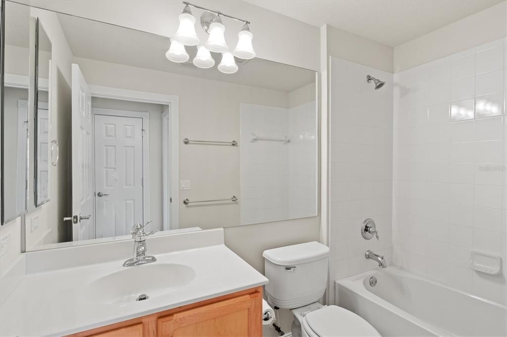 13222 Huerta Street Venice, FL 34293 - Photo 34 of 85 a bathroom with a toilet a sink a mirror a bathtub and vanity