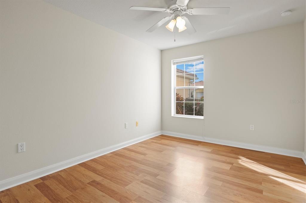 13222 Huerta Street Venice, FL 34293 - Photo 35 of 85 a view of an empty room with wooden floor and a window