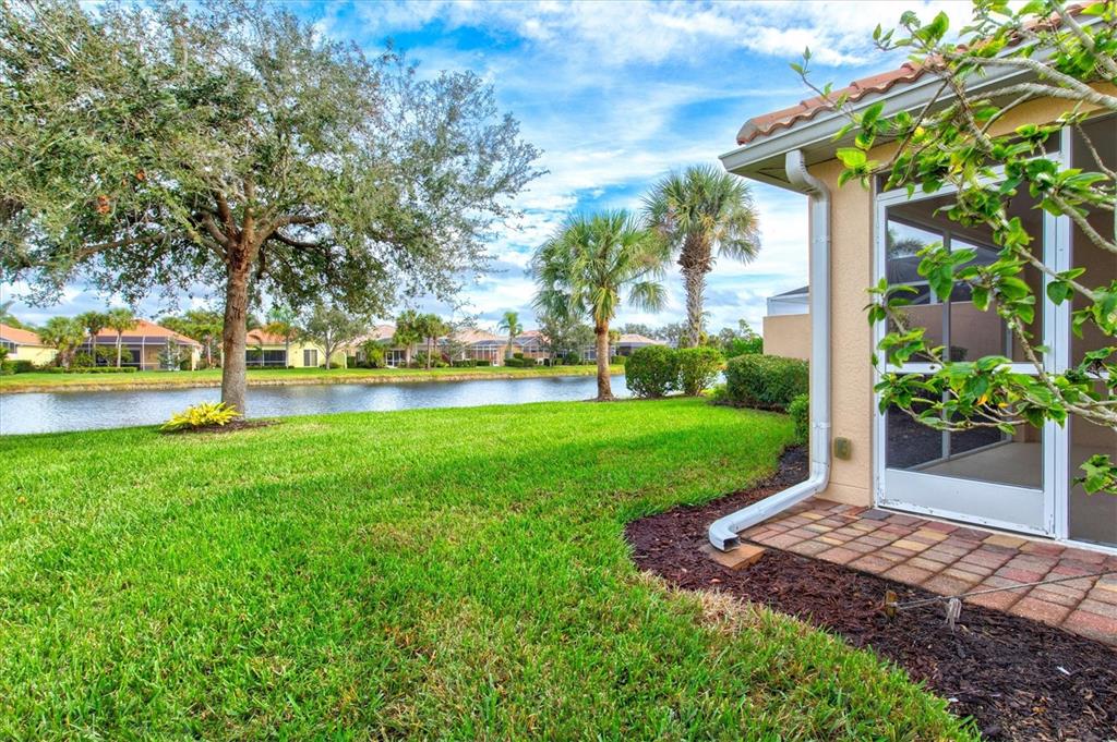 13222 Huerta Street Venice, FL 34293 - Photo 47 of 85 a view of a house with garden and a tree