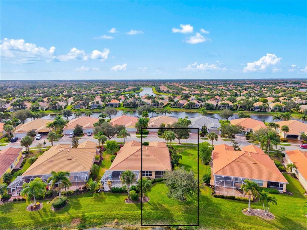 13222 Huerta Street Venice, FL 34293 - Photo 52 of 85 an aerial view of a house with a lake view