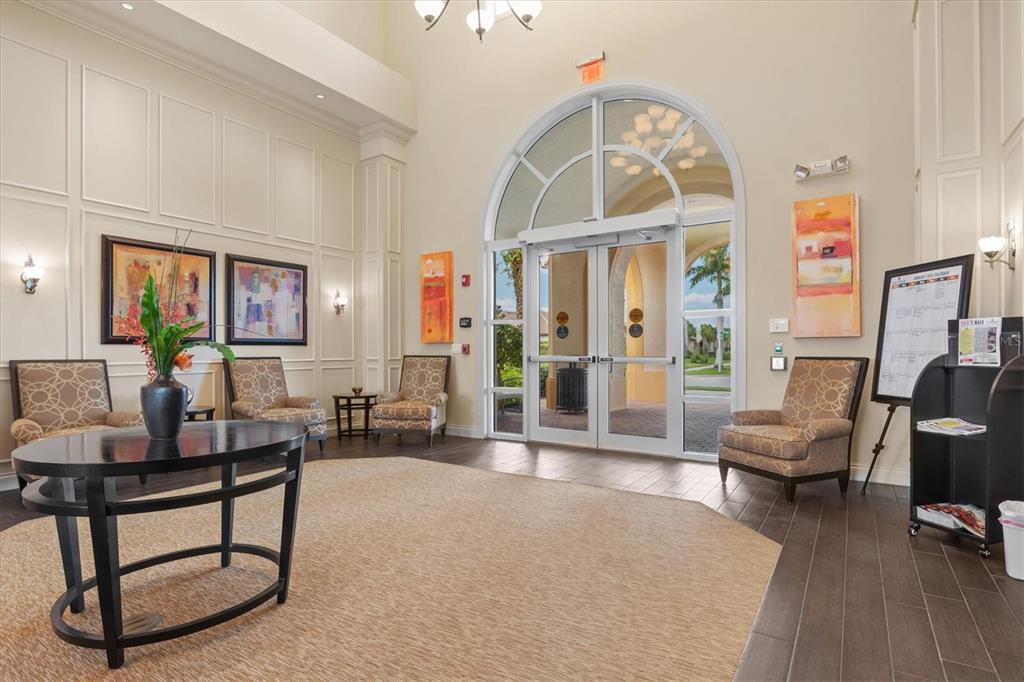 13222 Huerta Street Venice, FL 34293 - Photo 57 of 85 a living room with furniture a wooden floor and a large window
