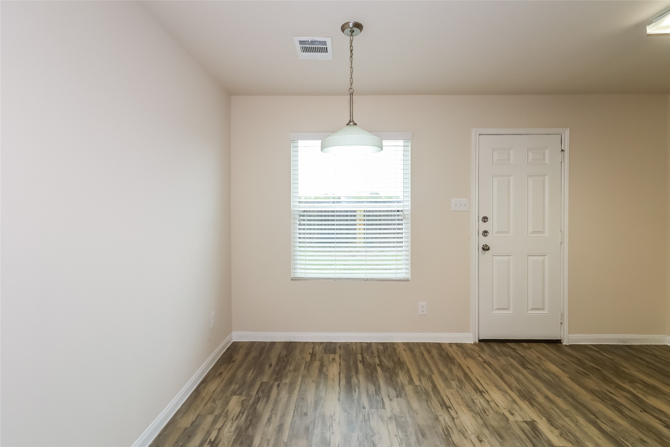 5826 Dawn Terrace Court Houston, TX 77048 - Photo 6 of 14 an empty room with wooden floor and windows