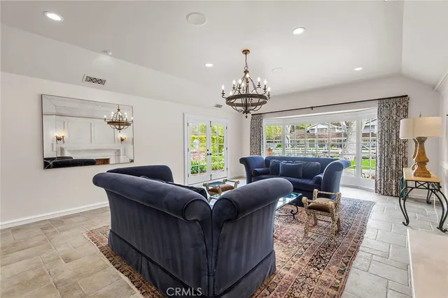 a living room with furniture and a chandelier