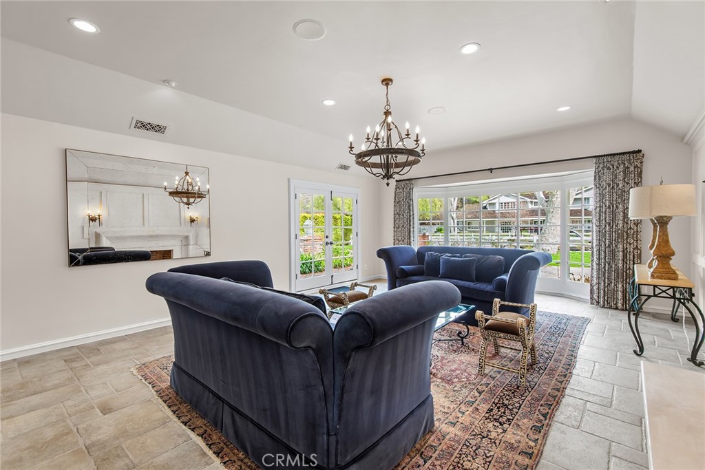 24308 Bridle Trail Road Hidden Hills, CA 91302 - Photo 11 of 29 a living room with furniture and a chandelier