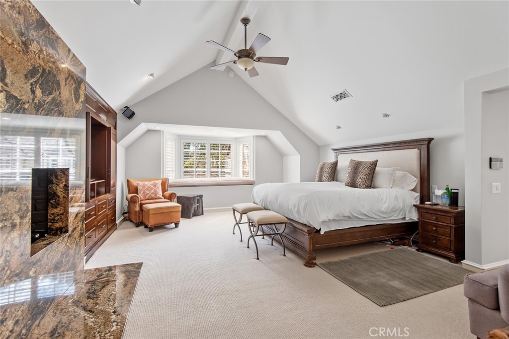 24308 Bridle Trail Road Hidden Hills, CA 91302 - Photo 14 of 29 a bedroom with a bed couch and a flat tv screen