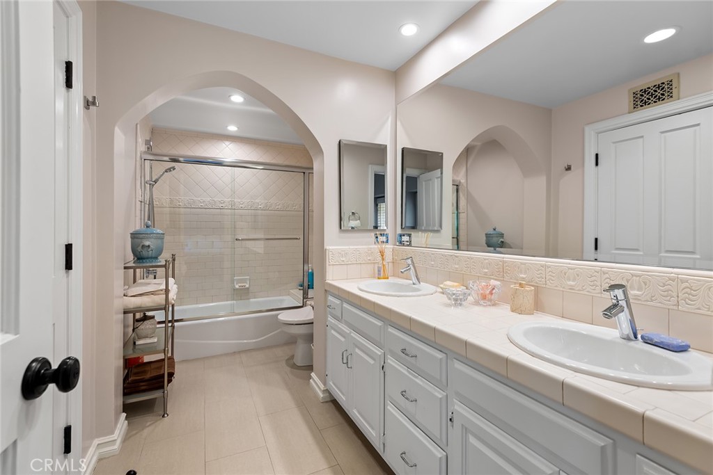 24308 Bridle Trail Road Hidden Hills, CA 91302 - Photo 18 of 29 a spacious bathroom with a tub double sink and mirror