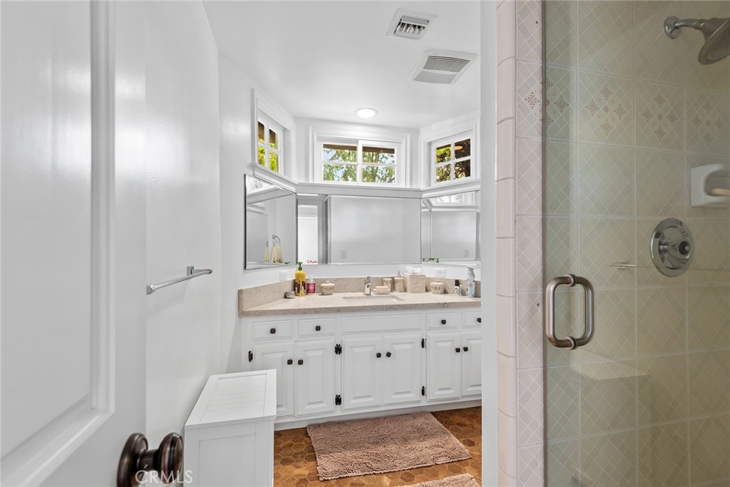 24308 Bridle Trail Road Hidden Hills, CA 91302 - Photo 20 of 29 a bathroom with a sink mirror and a shower