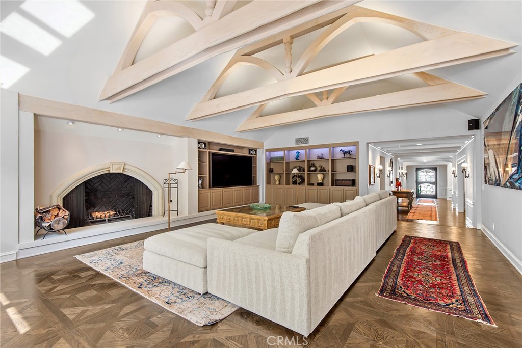 24308 Bridle Trail Road Hidden Hills, CA 91302 - Photo 5 of 29 a living room with furniture a fireplace and a flat screen tv